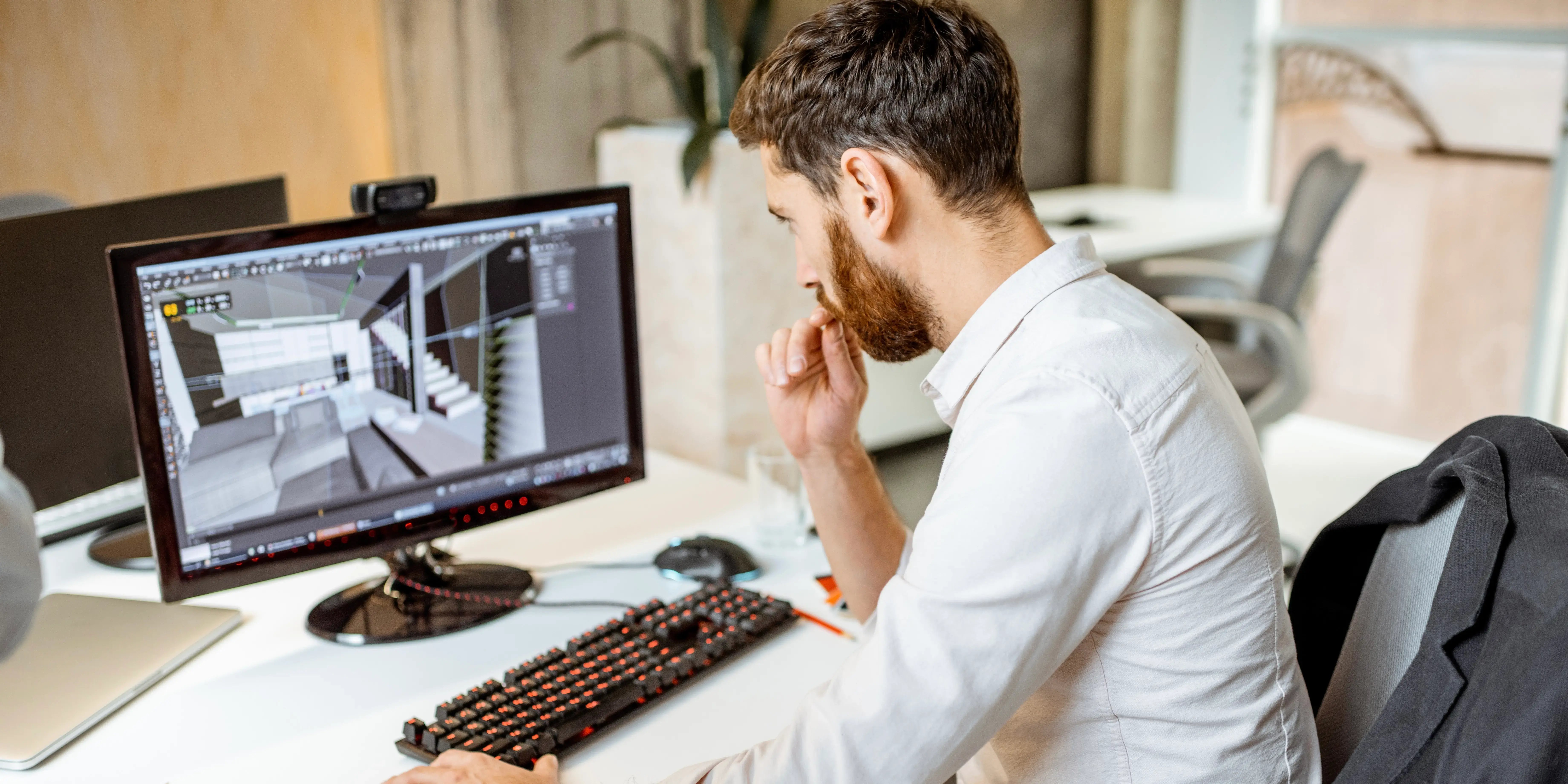Hombre en una computadora viendo el render 3d de una casa de un desarrollo inmobiliario