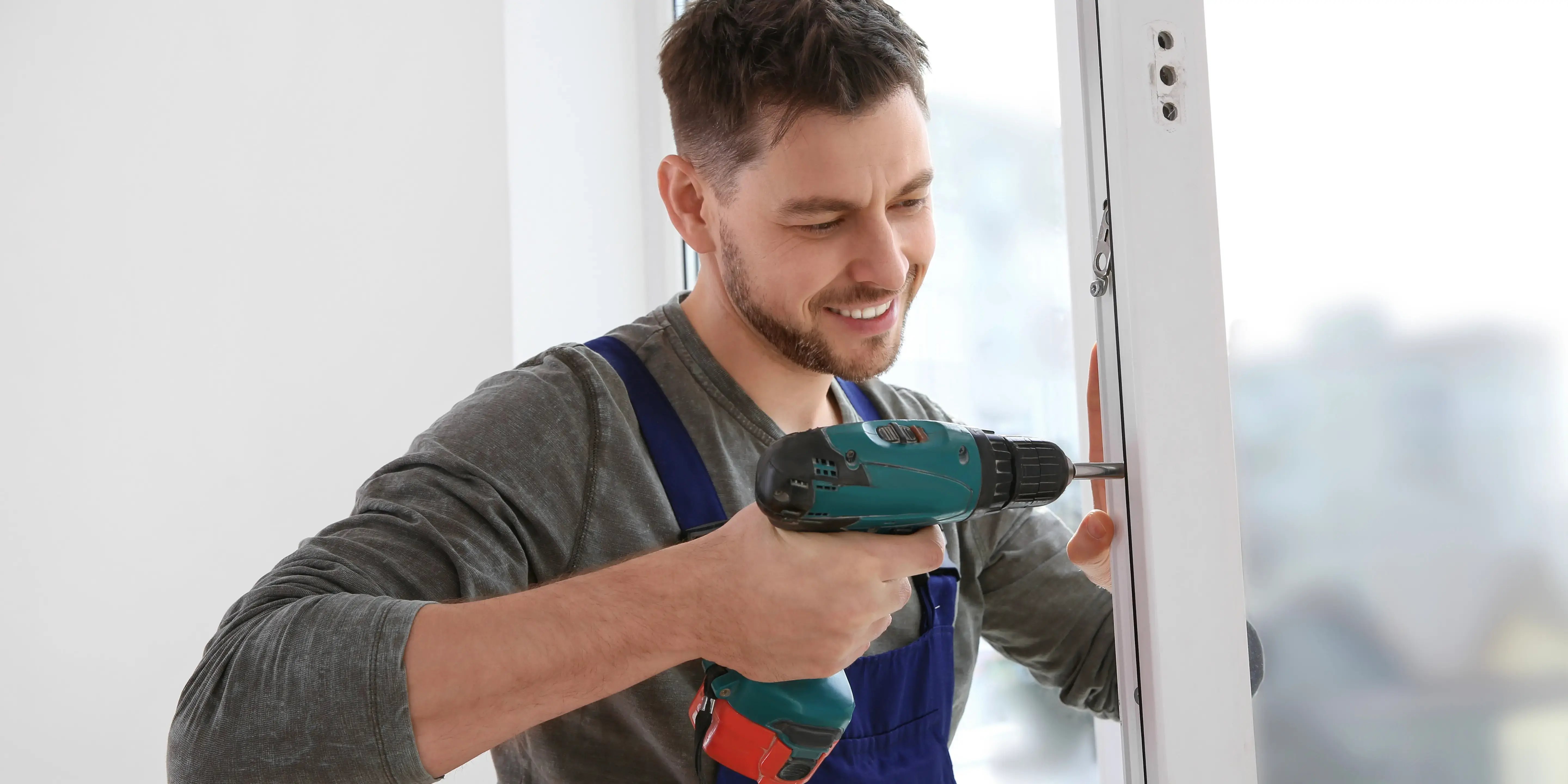 Hombre sosteniendo un taladro para darle mantenimiento a su casa y no pierda plusvalía