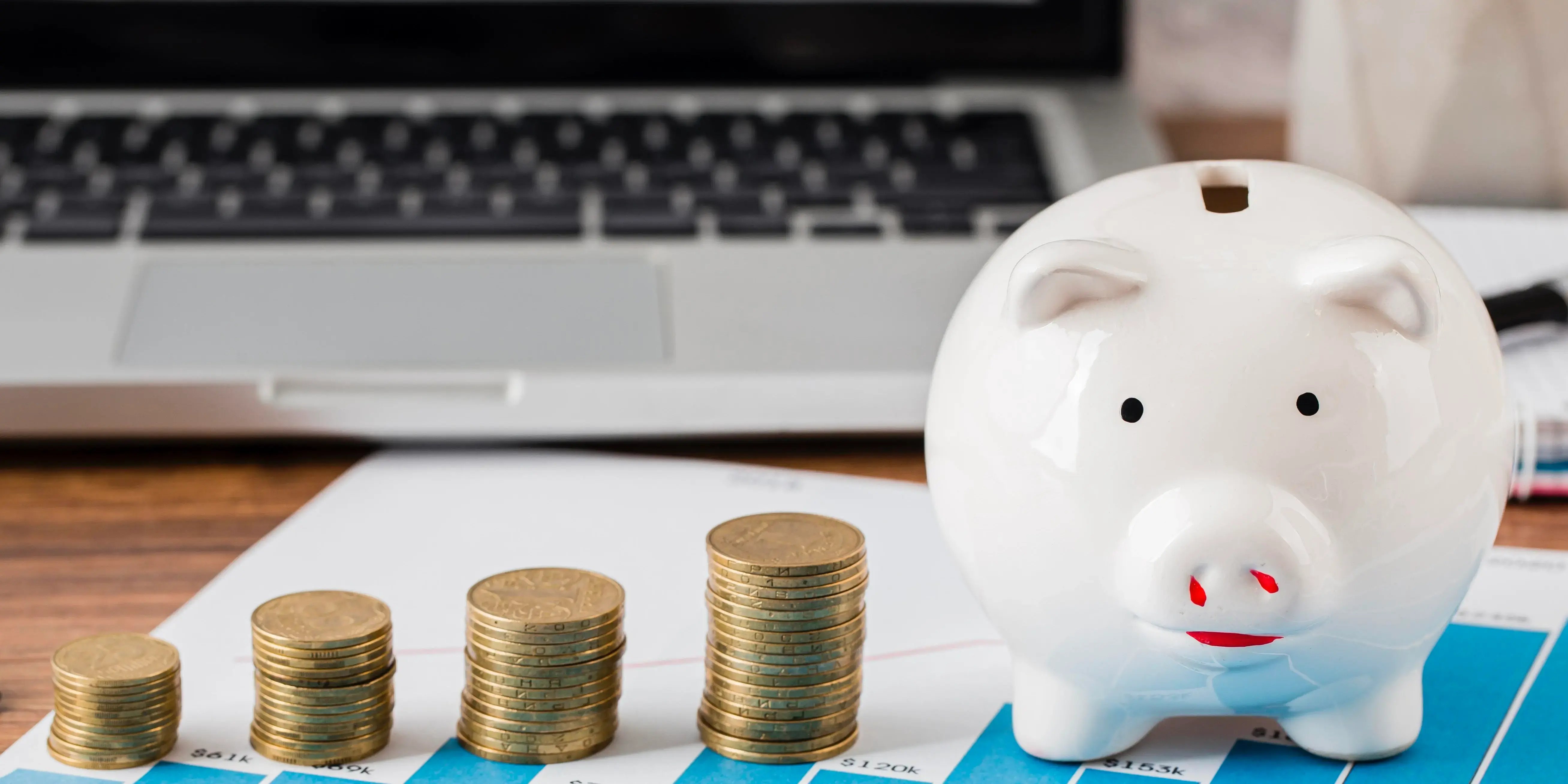 Pilas de monedas y alcancía de marrano. front-view-office-items-with-piggy-bank-coinscomo administrar mi dinero