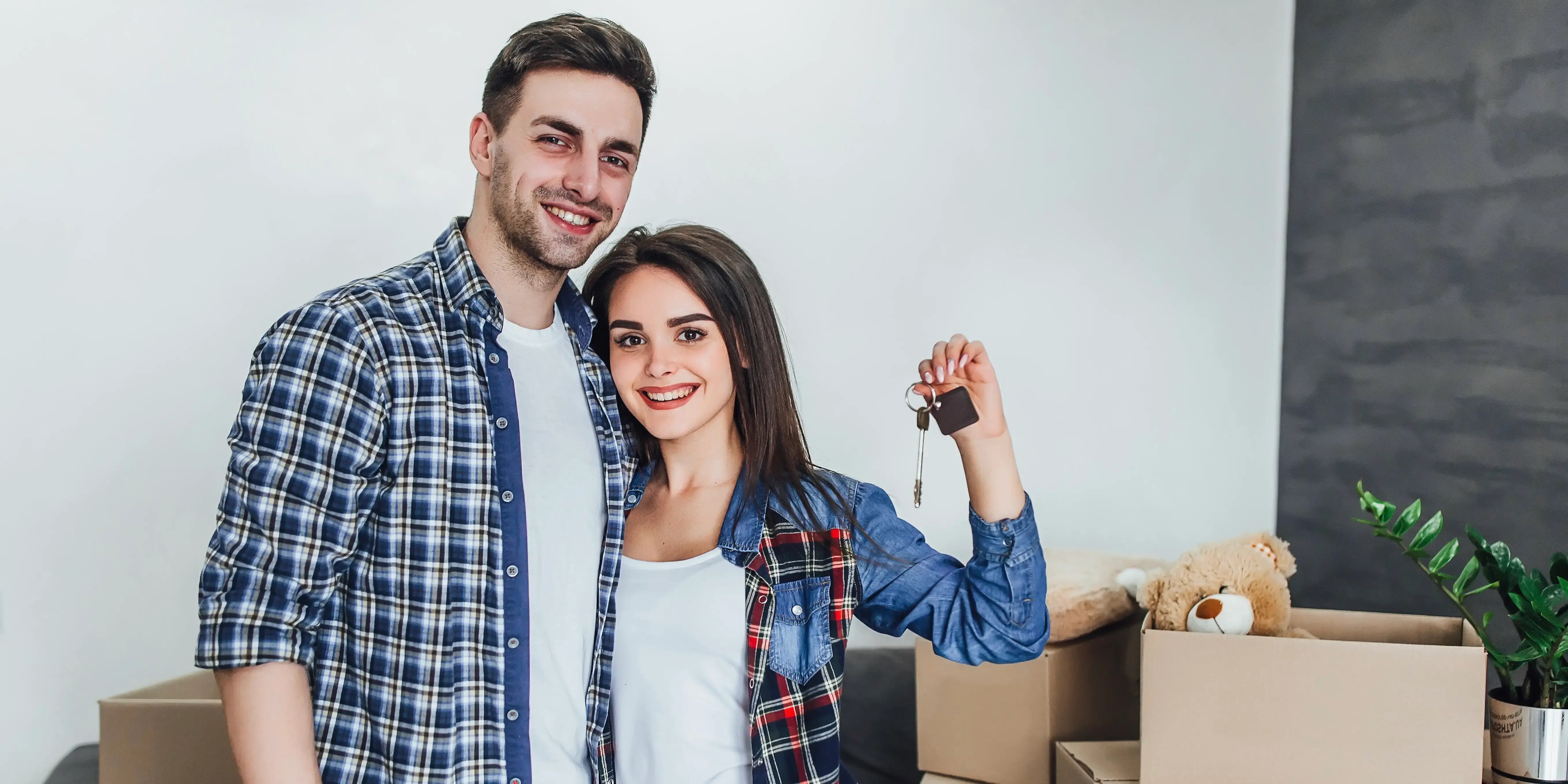 Pareja sosteniendo llaves de la casa. Buen mes